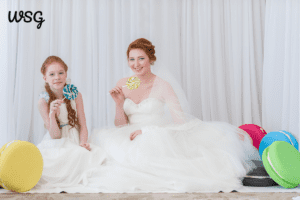 Bride and matron of honor enjoying lollipops, ideal for matron of honor speech for best friend.