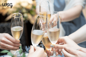 Champagne glasses clinking during a wedding toast celebration.