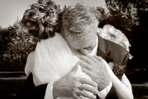 Black and white image of father hugging his daughter at her wedding.Father of the bride speech example.