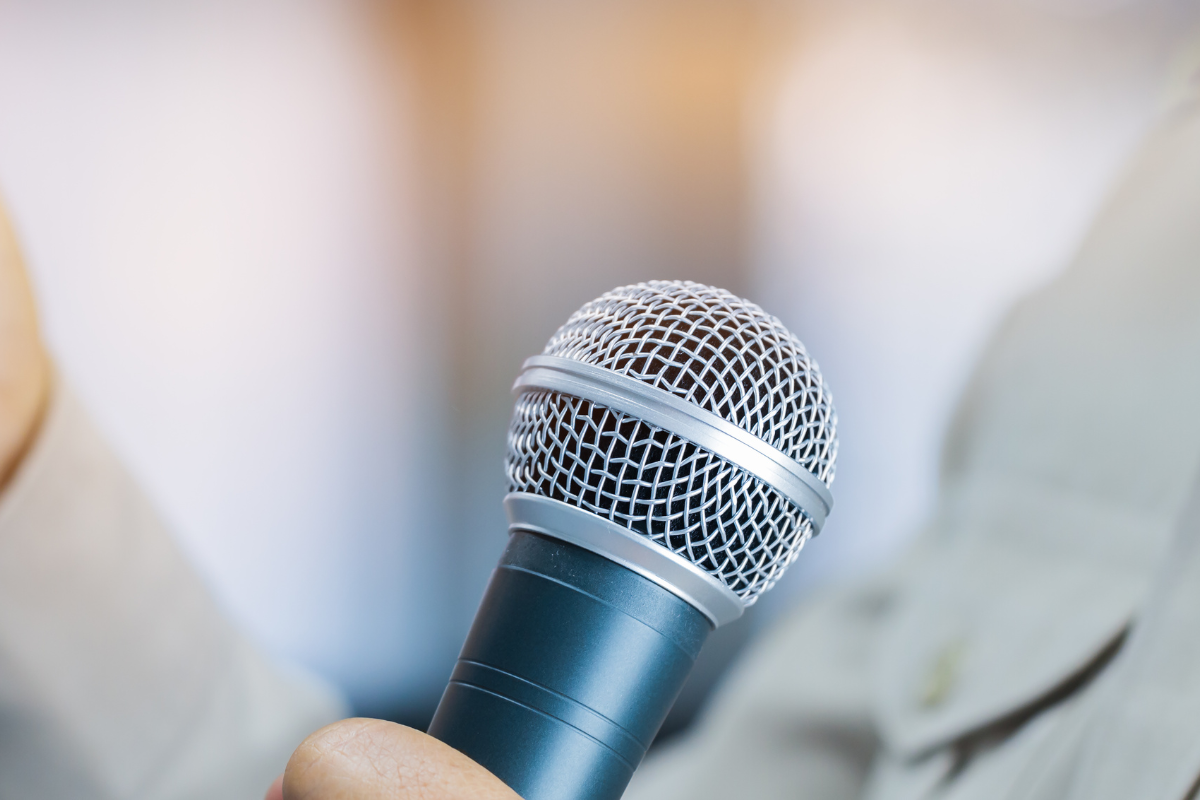 a close up image of microphone being held