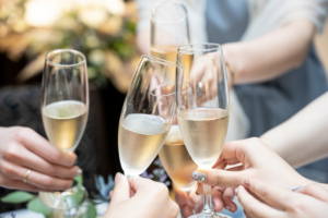 5 people toasting in a wedding setting.