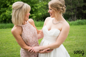 Mother and daughter sharing a joyful moment before the daughter’s wedding speech