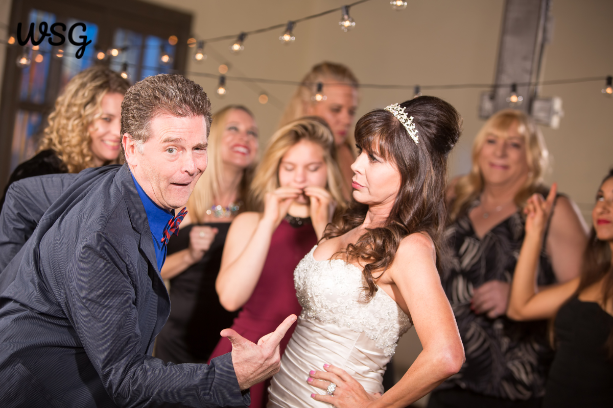 Wedding speech humor with the bride and guests laughing during a funny moment.