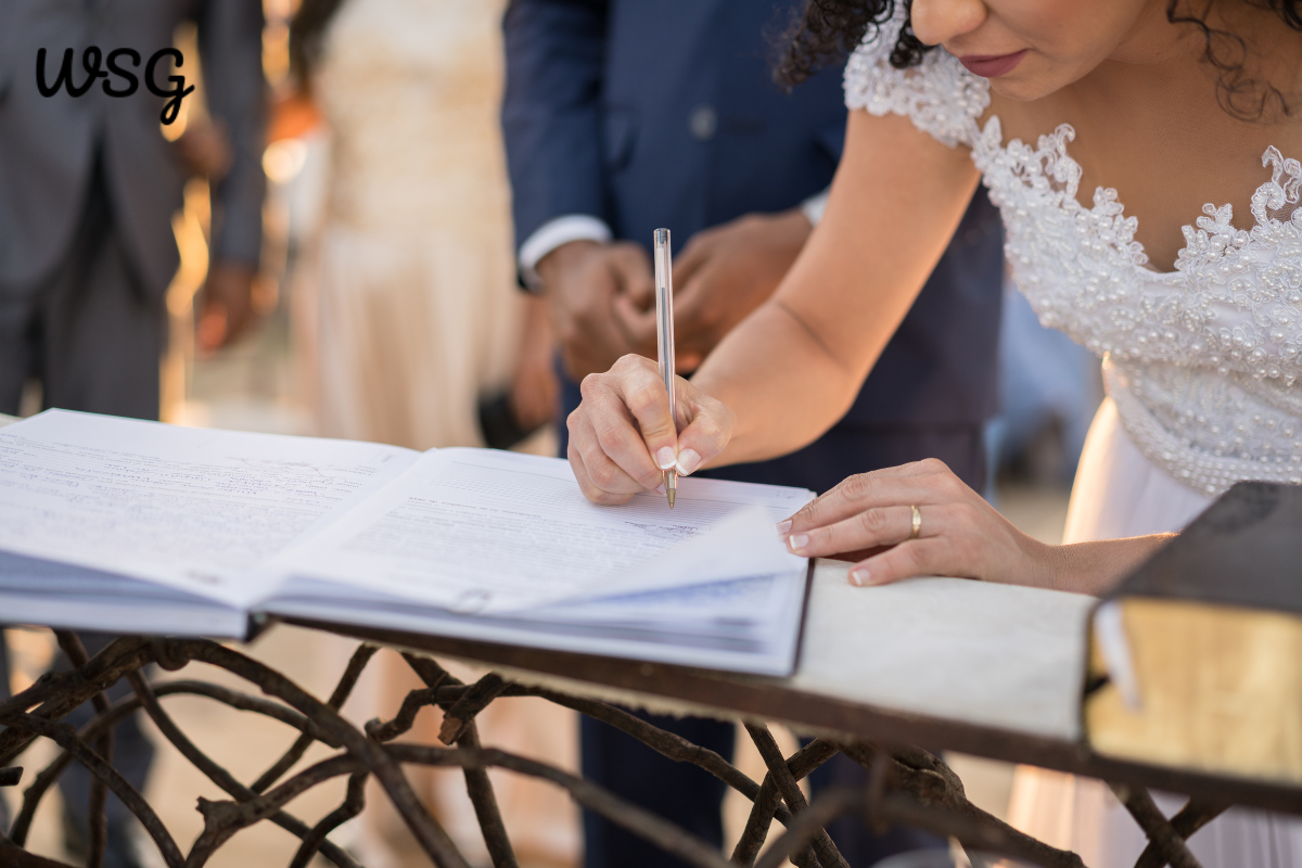 Bride signing wedding officiant speech script at ceremony