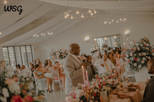 A man giving a heartfelt wedding speech example at a beautifully decorated reception